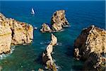 Sailboat and Rock Formations at Lagos, Algarve Coast, Portugal