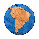 South America on wooden model of planet Earth with embossed continents and visible country borders. 3D illustration isolated on white background.