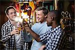 Smiling man with a beer at a bar