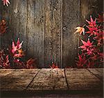 Wooden table. Autumn design with leaves and empty display. Space for your montage. Season fall background