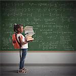 Child with backpack and a study books pile with blackboard background