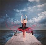 Classical dancer with tutu dancing on a floating dock