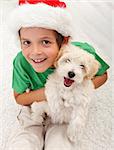 The best christmas present ever - young boy with her puppy dog