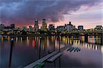 Portland Oregon city downtown waterfront skyline along Willamette River after sunset at dusk