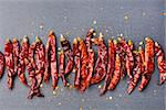 Dried red chili peppers on slate background Copy space Top view