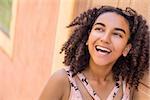Outdoor portrait of beautiful happy mixed race African American girl teenager female young woman smiling with perfect teeth