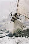 Close up on the bow of a sailing boat or yacht breaking through a wave on a stormy sea