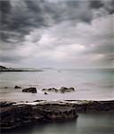 Peaceful Winter Seascape. Cold Sea or Ocean with Dramatic Sky. Long Exposure. Calm Water and Moody Sky. Cold Mysterious Tranquility Concept. Toned Photo with Copy Space.