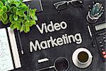 Video Marketing Handwritten on Black Chalkboard. Top View Composition with Black Chalkboard with Office Supplies Around. 3d Rendering. Toned Illustration.