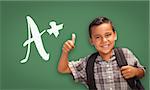 Cute Hispanic Boy with Thumbs Up in Front of A+ Written on Chalk Board.