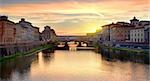 Ponte Vecchio on the river Arno in Florence at sunrise, Italy