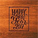 Happy New Year 2017 greeting card design. Sign with hand lettering inscription on wood background. Vector festive ilustration with typography.