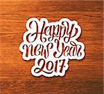Happy New Year 2017 greeting card design. Sticker with hand lettering inscription on wood background. Vector festive ilustration with typography.