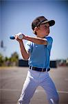 Young boy swinging a baseball bat.