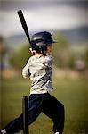 child swings baseball bat