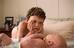 View of a little boy looking at a baby.