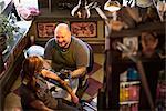 Woman getting her arm tattooed at a tattoo parlour.