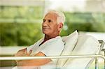 Portrait of senior male patient in a hospital bed looking reflective.