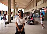 Young businesswoman wearing sunglasses,  waiting for train.