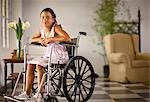 Portrait of young girl sitting in wheelchair.