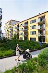 Sweden. Sodermanland, Hammarby Sjostad, Woman pushing baby carriage