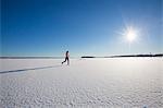 Sweden, Medelpad, Sundsvall, Woman running on snowy day