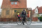 Sweden, Sodermanland, Stockholm, Man holding bicycle with son (2-3) on back seat