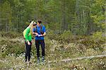 Sweden, Vasterbotten, Grossjons Nature Reserve, Man and woman looking at map