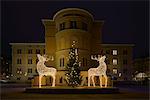 Sweden, Uppland, Stockholm, Illuminated Christmas reindeers in front of building