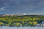 Sweden, Uppland, Stockholm, Cityscape with trees on cloudy day