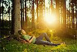 Finland, Heinola, Paijat-Hame, Man sleeping in spruce forest