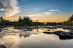 Finland, Pohjois-Pohjanmaa, Oulu, Forest and river at sunset