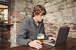 Man using laptop at bar