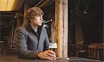 Thoughtful man sitting in bar with glass of beer on table