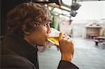 Thoughtful man having glass of beer in bar