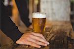 Man with glass of beer at bar