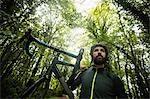 Athlete carrying a bicycle in forest