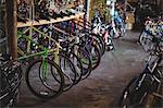 Multicolored bicycles arranged in a row in workshop
