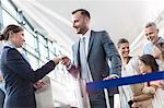 Flight attendant checking tickets in airport