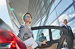 Businesswoman arriving at airport getting out of town car