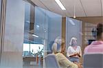 Businesswoman leading meeting in conference room