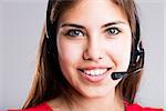 young woman smiling wearing a headset to answer your customer for service