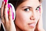 close up portrait of a young woman showing wonderful green big eyes while listening to her favourite music