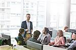 Businessman leading meeting in office
