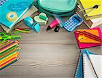 Colorful stationery on hardwood floor, school and learning concept.