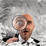 Businessman with a magnifying glass on sheets documents background