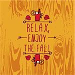 Hand-sketched typographic element with mulled wine, leaves and text on wooden background. Relax enjoy the fall