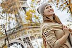 Autumn getaways in Paris. Portrait of happy young elegant woman in Paris, France looking into the distance