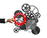 Businessman builds a business system putting a gear in a mechanism