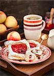 Delicious berry puff pastry with powdered sugar and coffee for breakfast